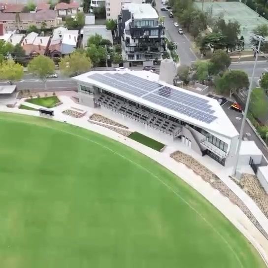 Rooftop solar array overlooking a sports oval