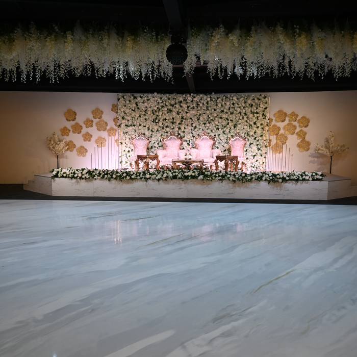 Wedding stage with floral wall and marble dance floor